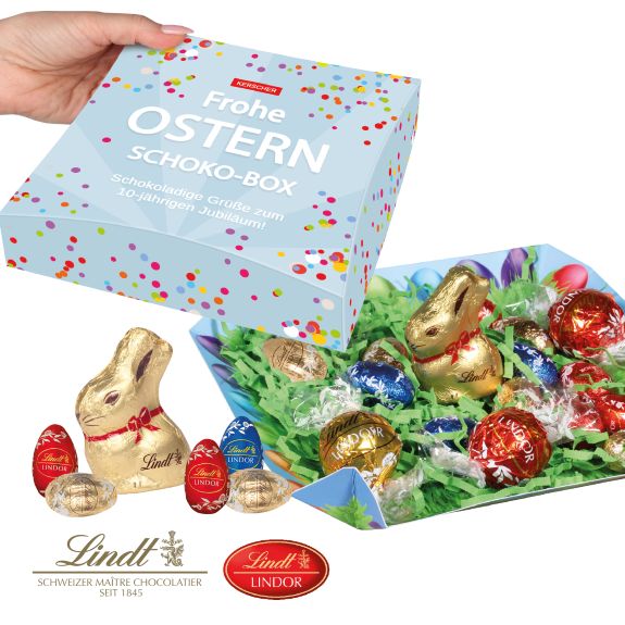 Lindt Osternest als Werbeartikel gefüllt mit Lindt Osterhase und Lindor Ostereier und Lindor Pralines-Kugeln mit Logo bedruckt als Werbeartikel.